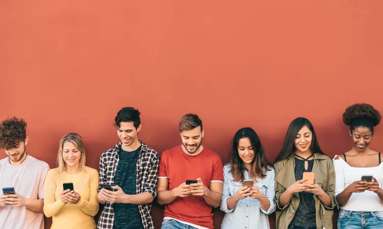 Group of people in a row looking at smartphones.