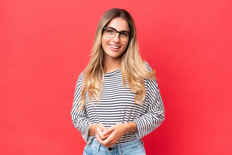 Young Uruguayan woman isolated on red background laughing.