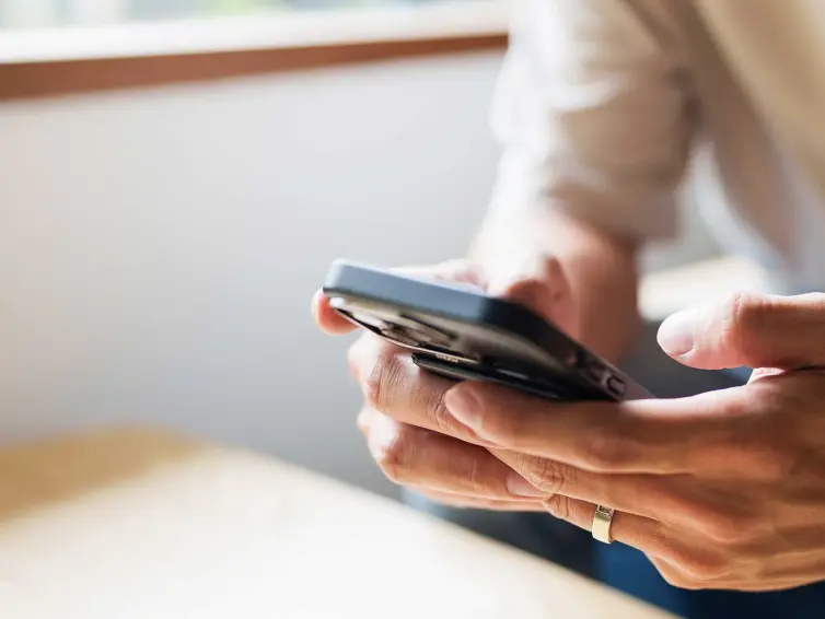 Pair of hands holding a smartphone.